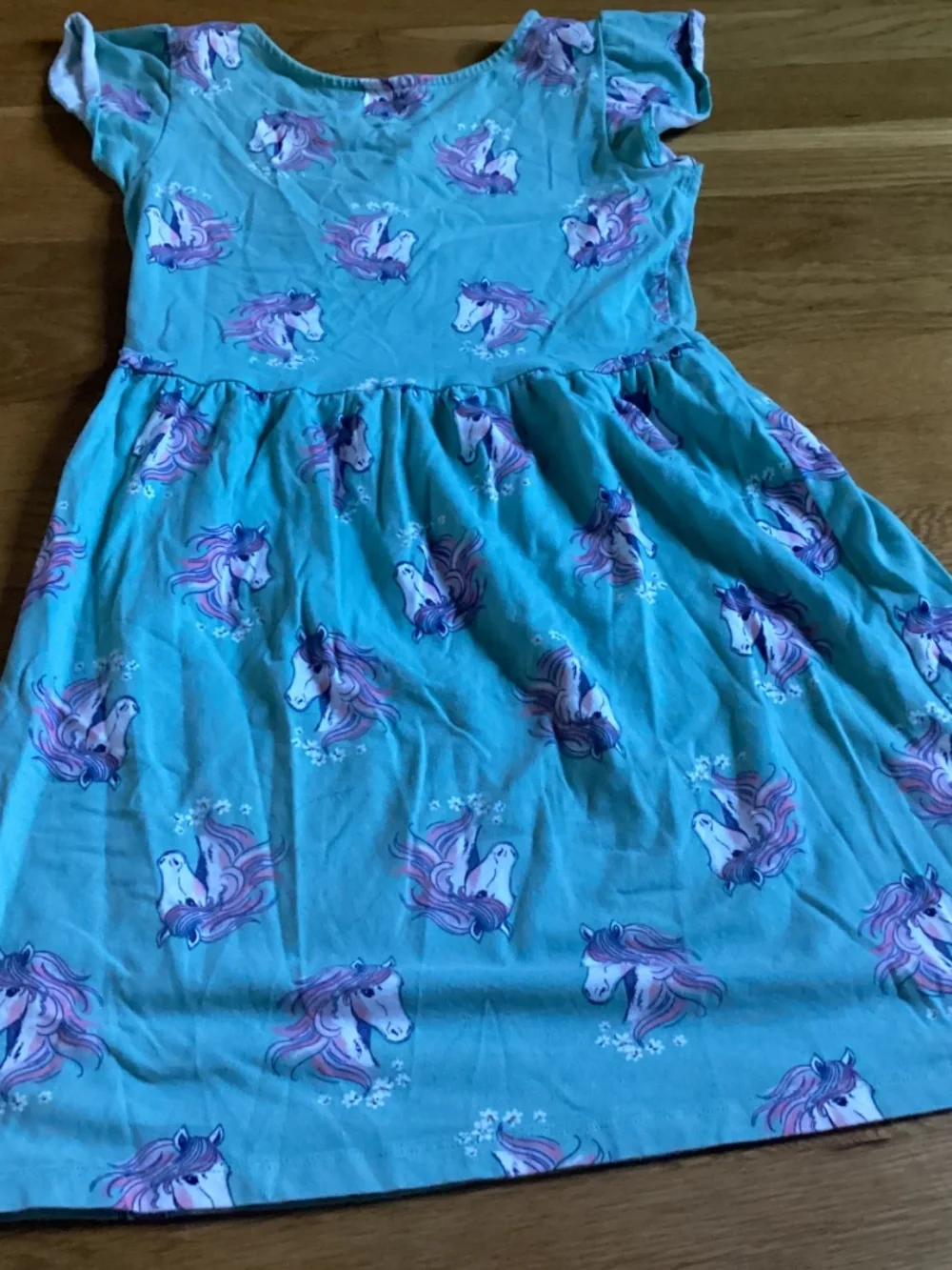 A Carter’s kid size 10 sage green dress with unicorns